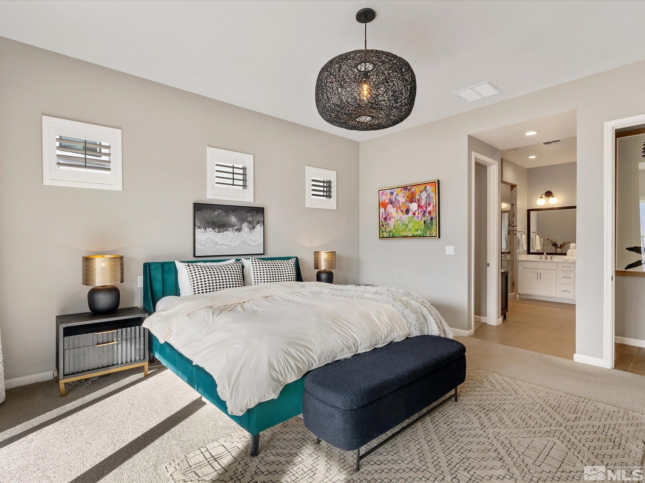 15033 Iron River Drive Reno, NV 89521 - Photo 25 of 39 a bedroom with a large bed and a chandelier