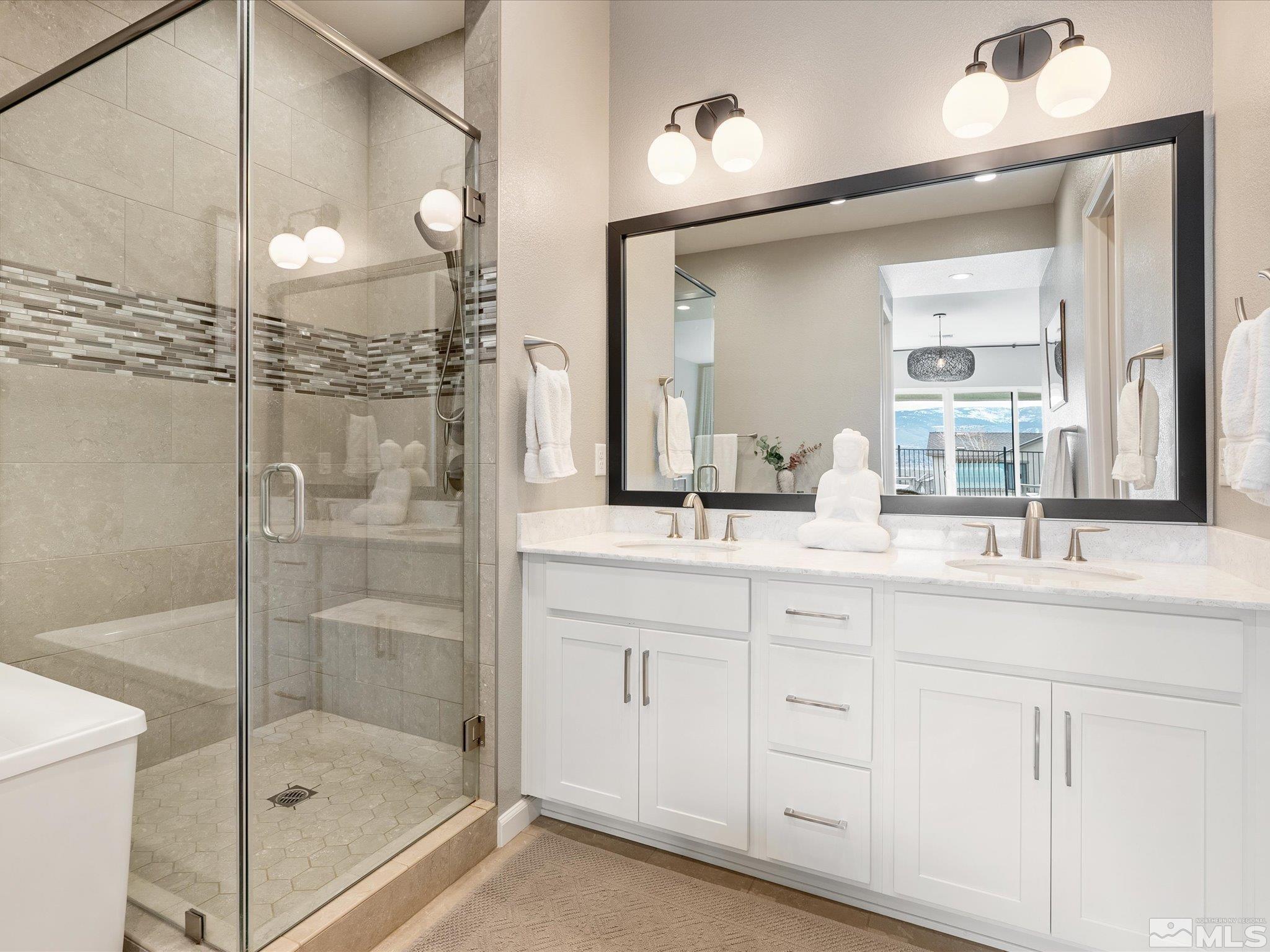 15033 Iron River Drive Reno, NV 89521 - Photo 28 of 39 a bathroom with a shower sink and mirror
