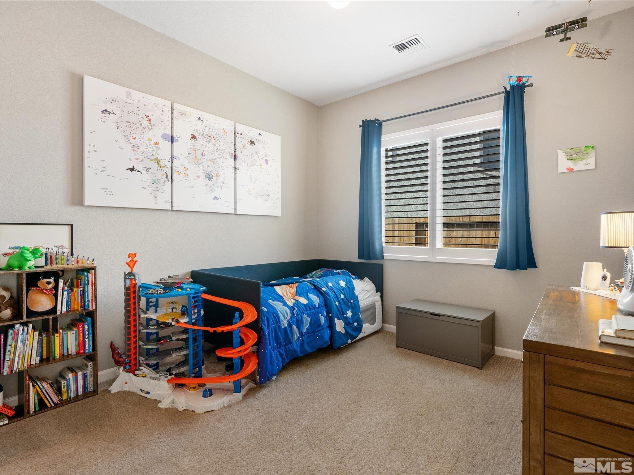 15033 Iron River Drive Reno, NV 89521 - Photo 32 of 39 a bedroom with furniture and a book shelf