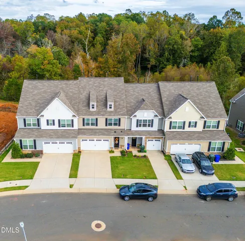an aerial view of a house with swimming pool and ocean view
