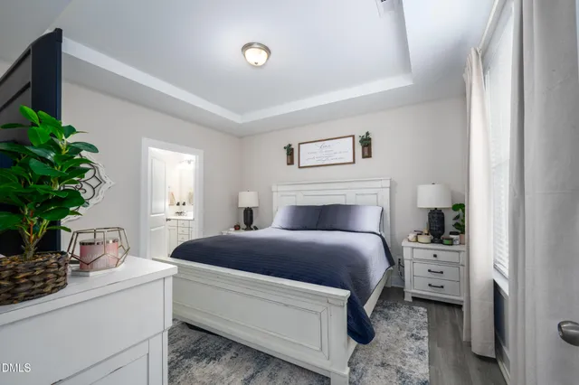 a bedroom with a bed and a potted plant