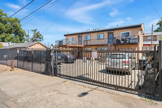 a view of a house with a wooden fence