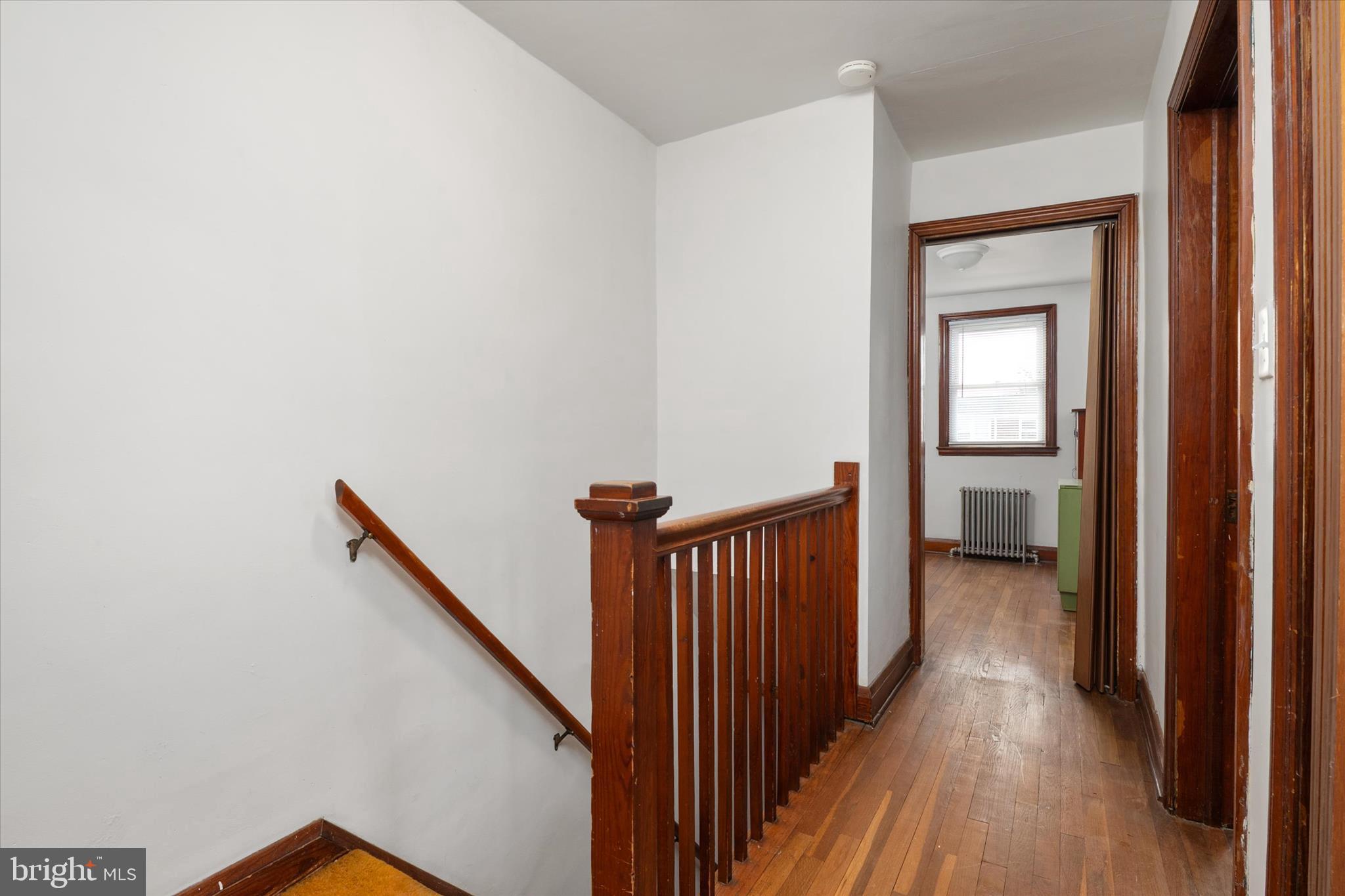 336 Arden Road West Baltimore, MD 21225 - Photo 11 of 21 a view of a hallway with wooden floor and staircase