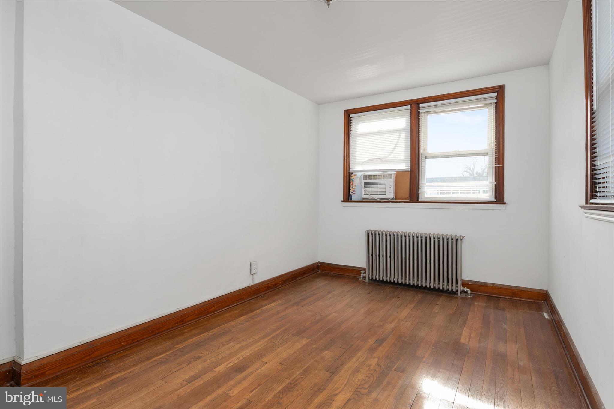 336 Arden Road West Baltimore, MD 21225 - Photo 15 of 21 an empty room with wooden floor and windows
