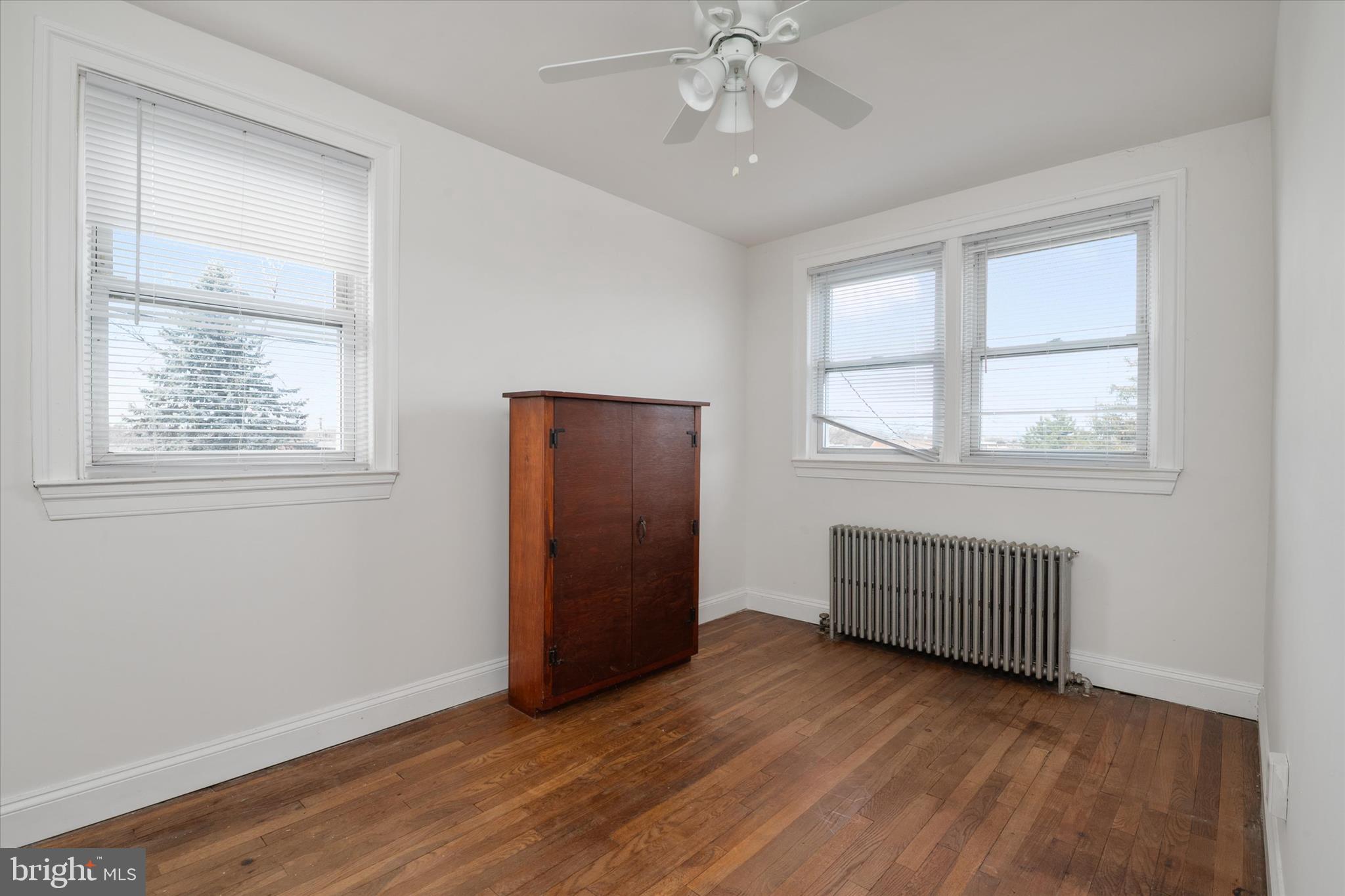 336 Arden Road West Baltimore, MD 21225 - Photo 18 of 21 a view of an empty room with wooden floor and a window