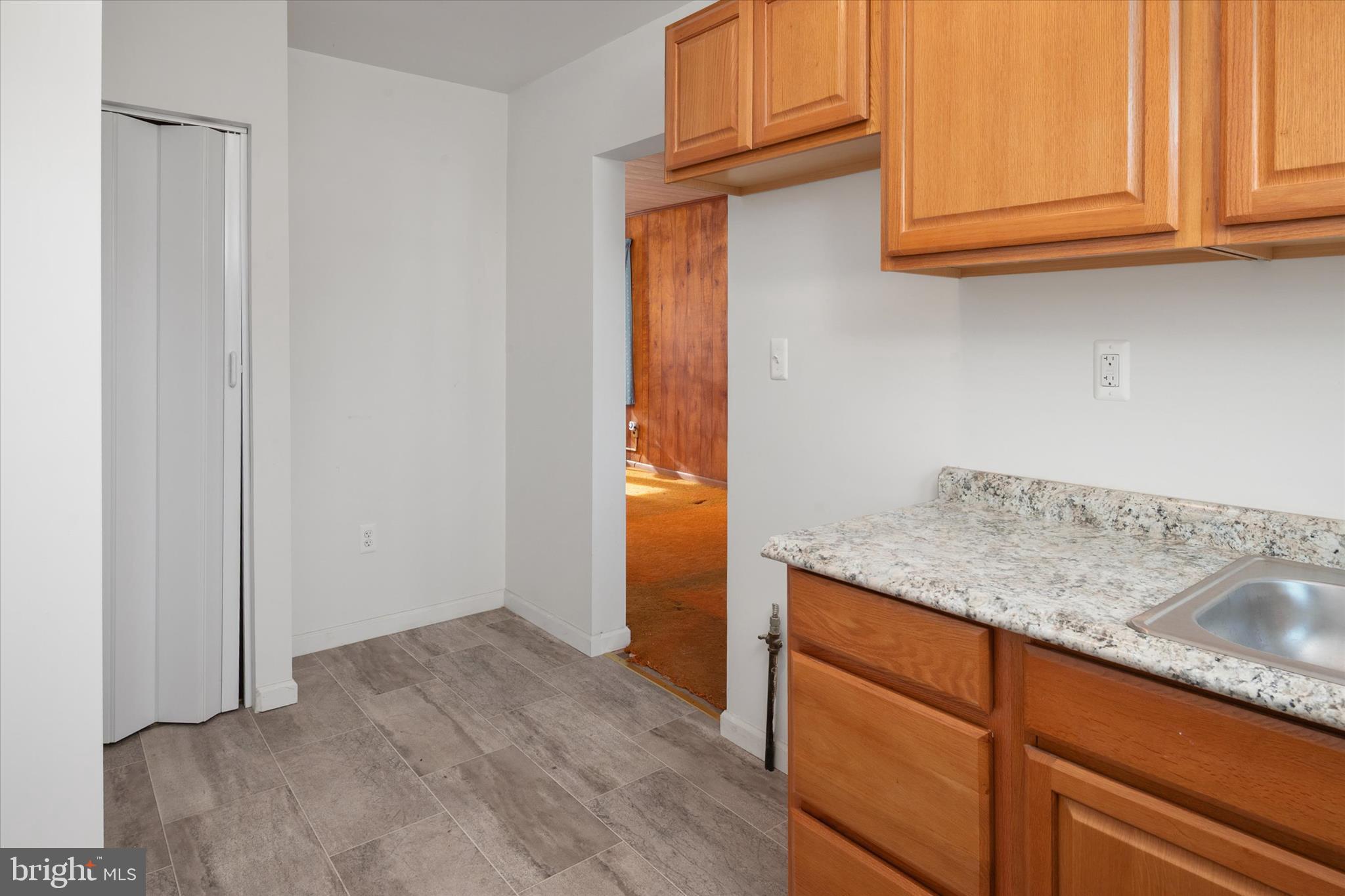 336 Arden Road West Baltimore, MD 21225 - Photo 10 of 21 a kitchen with granite countertop cabinets and sink