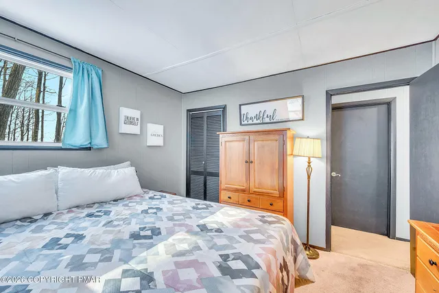 a bedroom with a bed and a potted plant