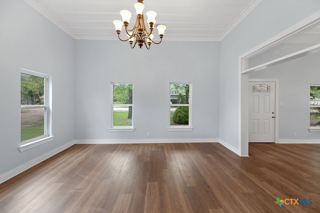 607 West 3rd Street Eddy, TX 76524 - Photo 8 of 29 a view of an empty room with wooden floor and a window