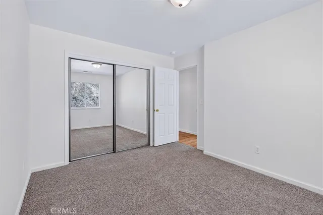 an empty room with mirror in closet