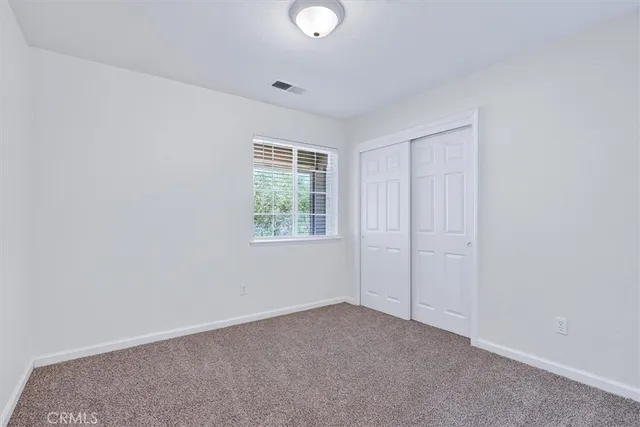 an empty room with windows and entrance