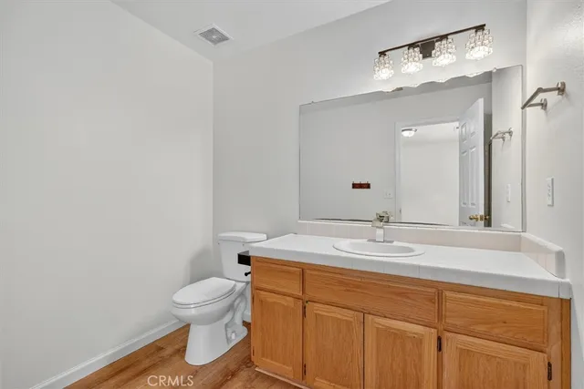 a bathroom with a sink a toilet and mirror