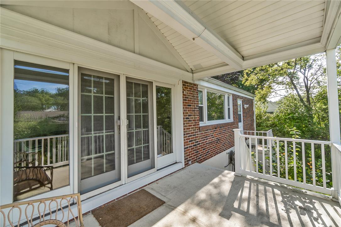 205 Bridle Path Road Bethlehem, PA 18017 - Photo 23 of 31 A covered concrete porch transitions seamlessly to sliding glass doors set against a brick exterior.