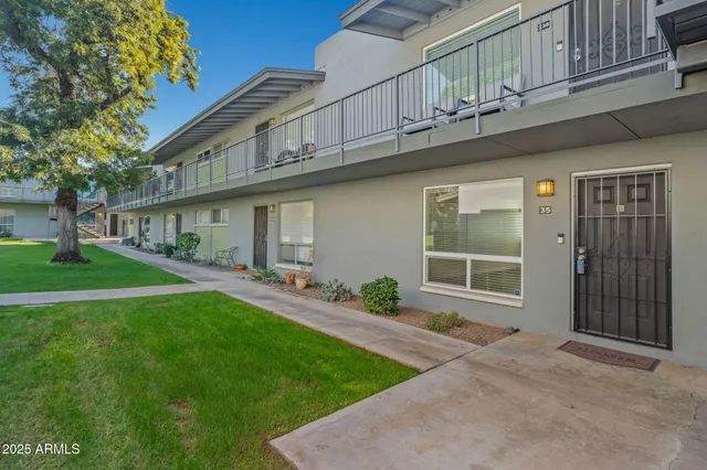 a view of house with a yard
