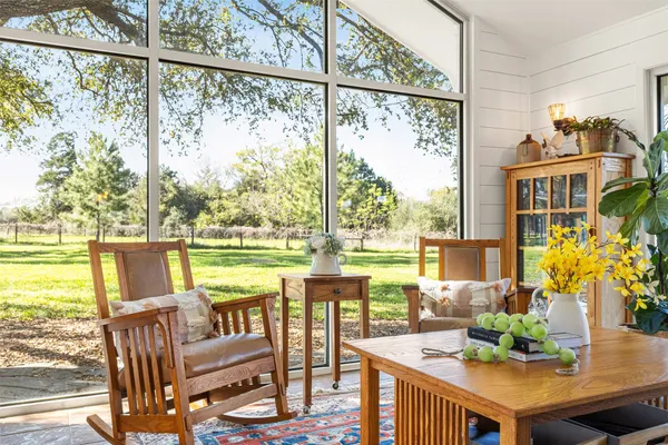 a living room with furniture and a floor to ceiling window