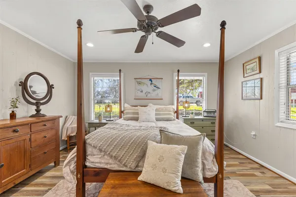 a bedroom with a bed dresser and a window