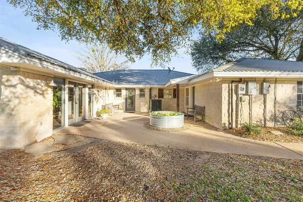 a view of a house with backyard porch and sitting area