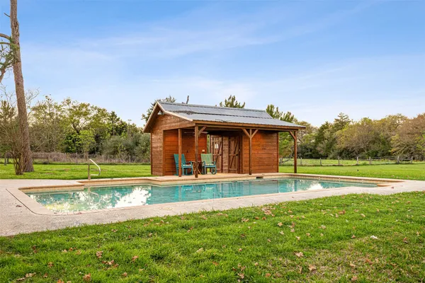 a view of a house with a yard and sitting area
