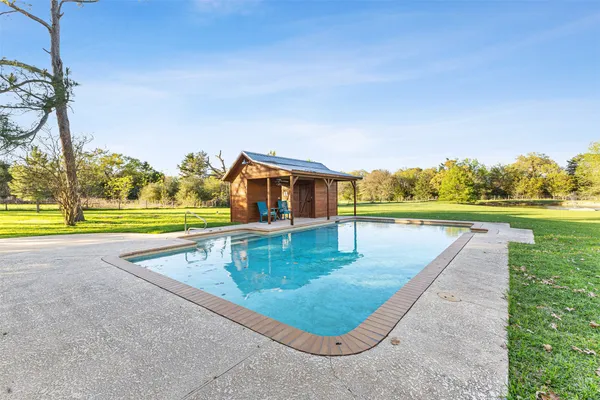 swimming pool view with a yard