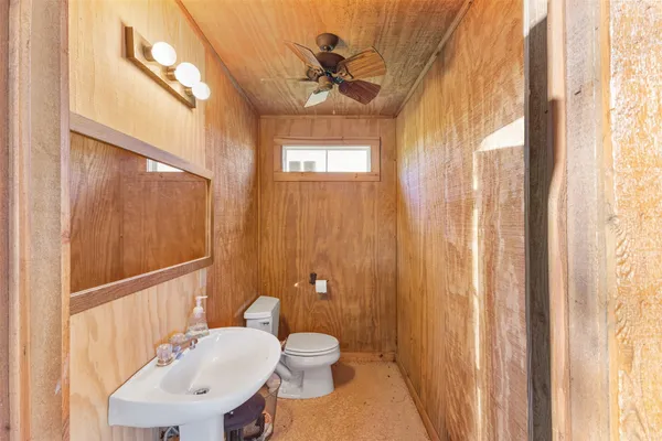 a bathroom with a toilet a sink and a mirror