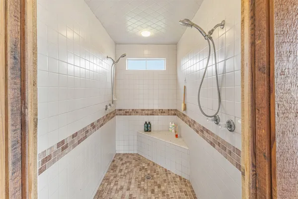a bathroom with a tub and a shower