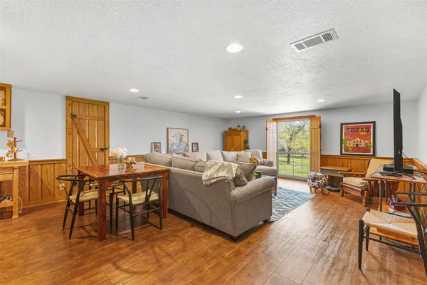 a living room with furniture and wooden floor