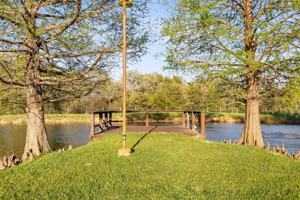 a view of outdoor space with wooden floor and lake view