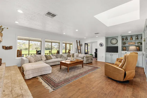 a living room with furniture and wooden floor