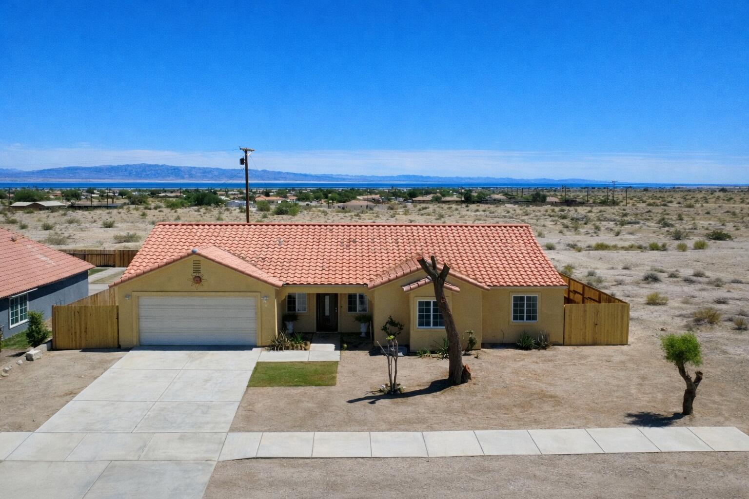 2778 Calhoun Street Thermal, CA 92274 - Photo 2 of 23 a front view of a house with a garden