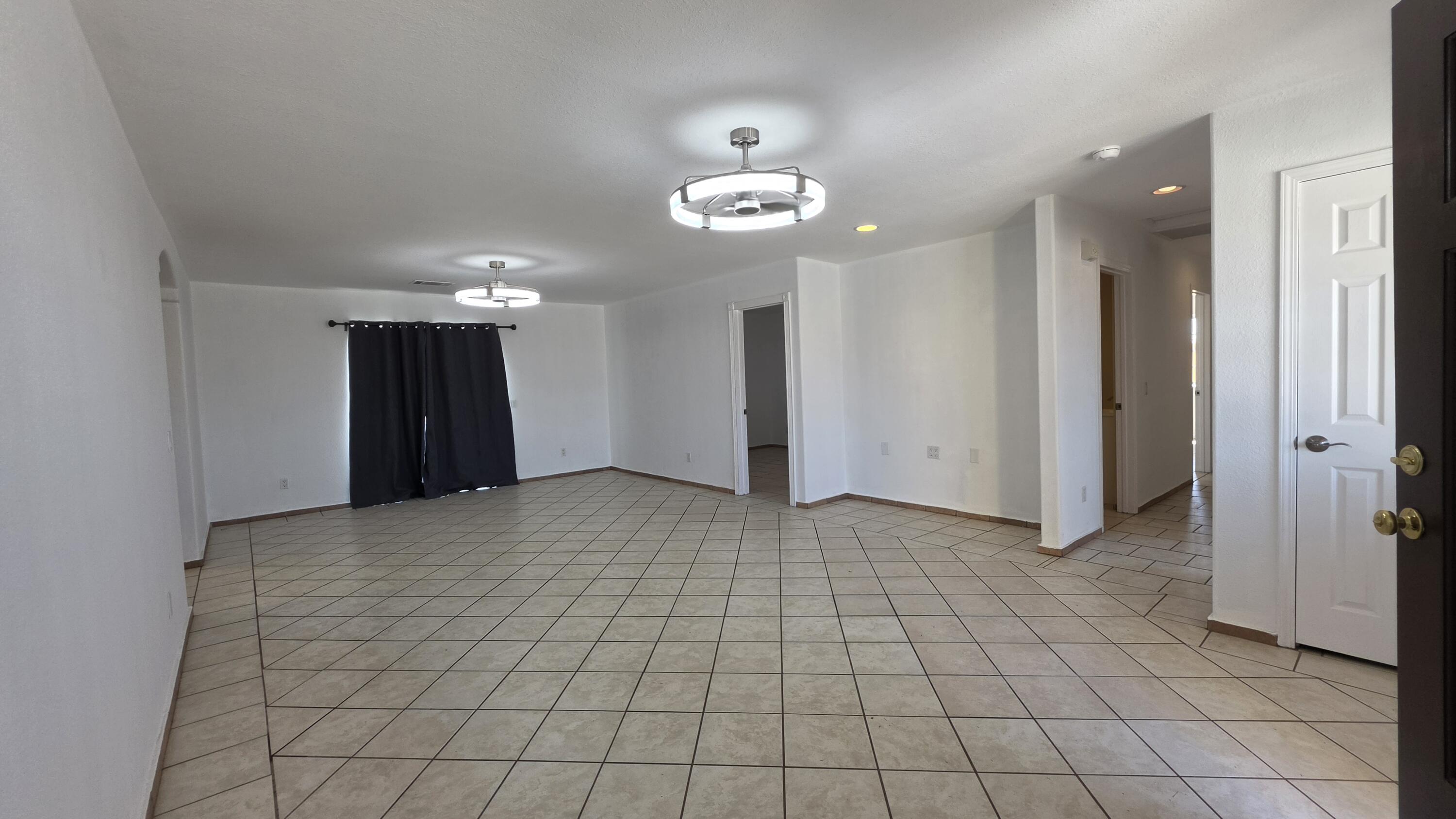 2778 Calhoun Street Thermal, CA 92274 - Photo 7 of 23 an empty room with kitchen and chandelier fan