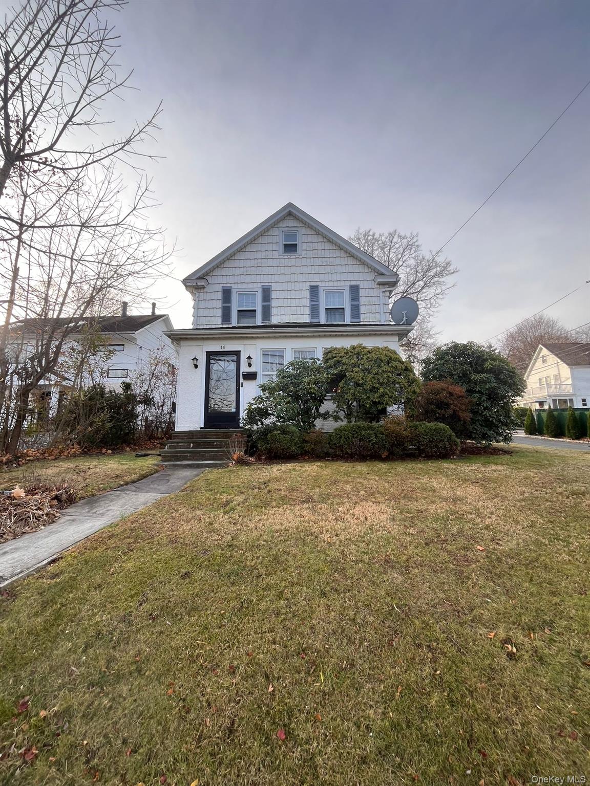 14 Redbrook Road Great Neck, NY 11024 - Photo 19 of 20 a front view of a house with a yard and garage
