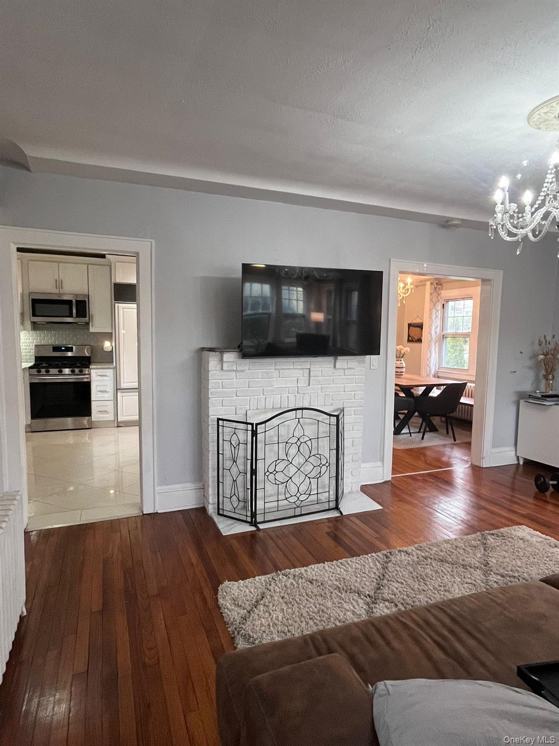 14 Redbrook Road Great Neck, NY 11024 - Photo 3 of 20 a living room with furniture and a flat screen tv