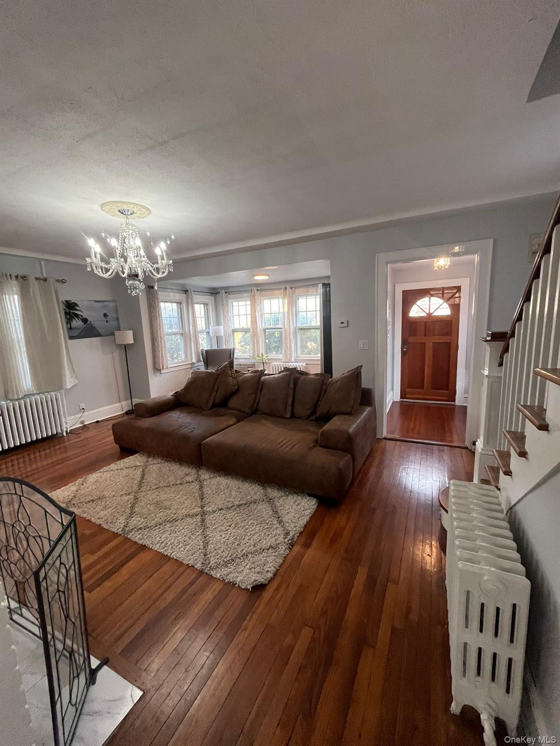 14 Redbrook Road Great Neck, NY 11024 - Photo 4 of 20 a living room with furniture and a chandelier