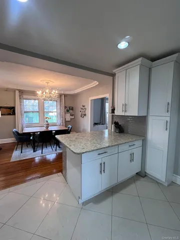 a kitchen with stainless steel appliances granite countertop a stove top oven a sink dishwasher and cabinets with granite countertops