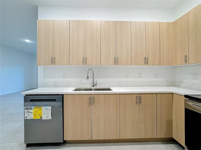 a kitchen with a sink and cabinets