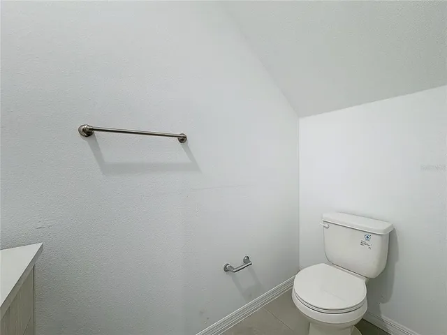 a white toilet sitting next to a white sink