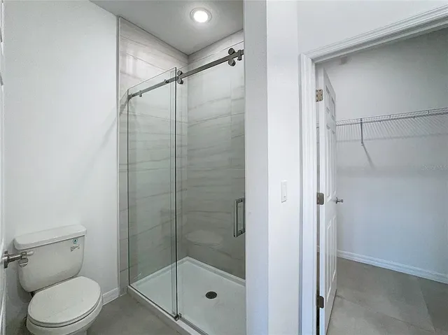 an empty room with a bathroom and a sink