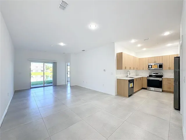 a view of a kitchen with a sink and cabinets