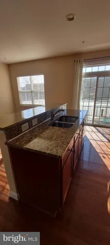 a kitchen with a stove and a window