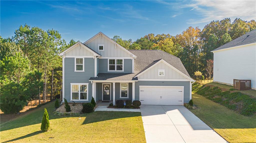 a front view of a house with a yard and garage