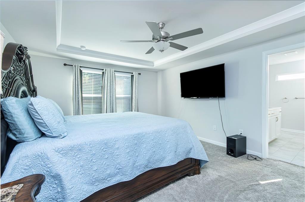 280 Mackenzie Court Covington, GA 30016 - Photo 14 of 24 a bedroom with a bed and a flat screen tv