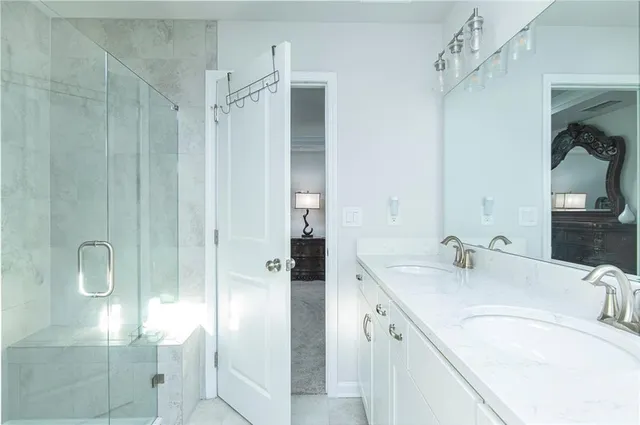 a bathroom with a granite countertop sink mirror and double