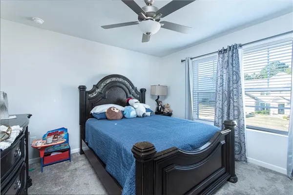 a bedroom with a bed and window