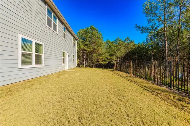 a view of a house with a backyard