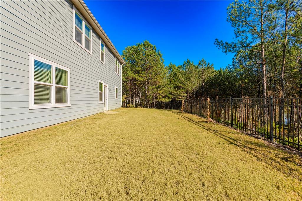 280 Mackenzie Court Covington, GA 30016 - Photo 22 of 24 a view of a house with a backyard