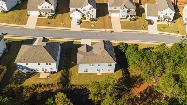 an aerial view of a house with a yard
