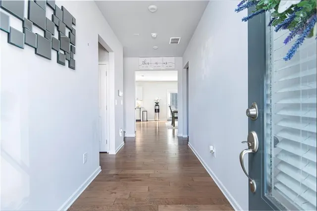 a view of a hallway with a potted plant on a shelf