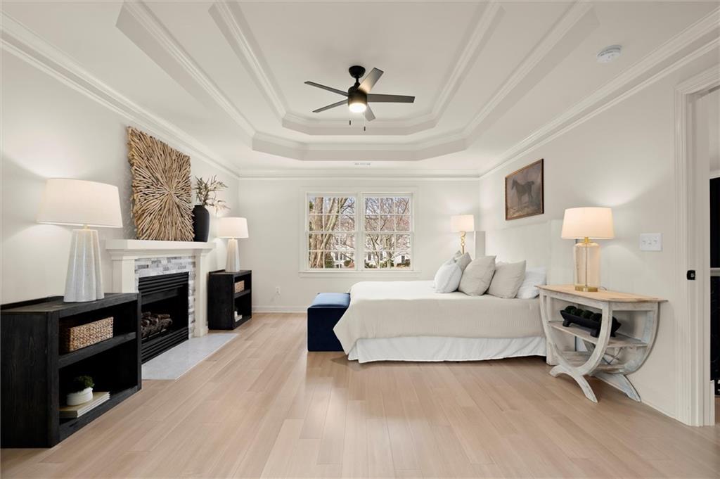 539 Schofield Drive Powder Springs, GA 30127 - Photo 21 of 45 a spacious bedroom with a large bed and a fireplace
