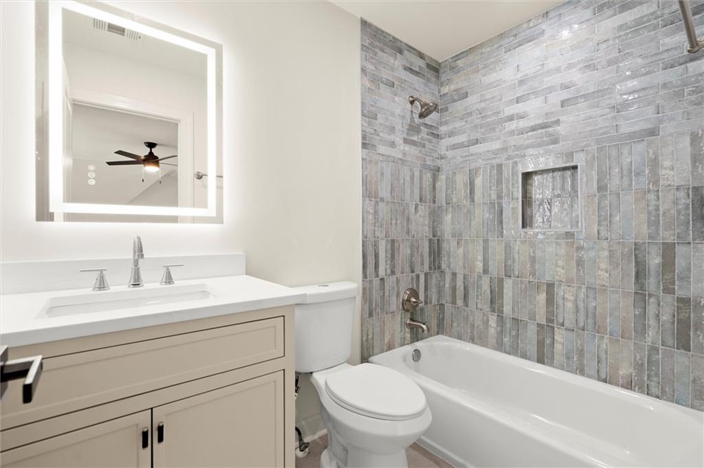 539 Schofield Drive Powder Springs, GA 30127 - Photo 25 of 45 a bathroom with a sink a toilet and a bathtub