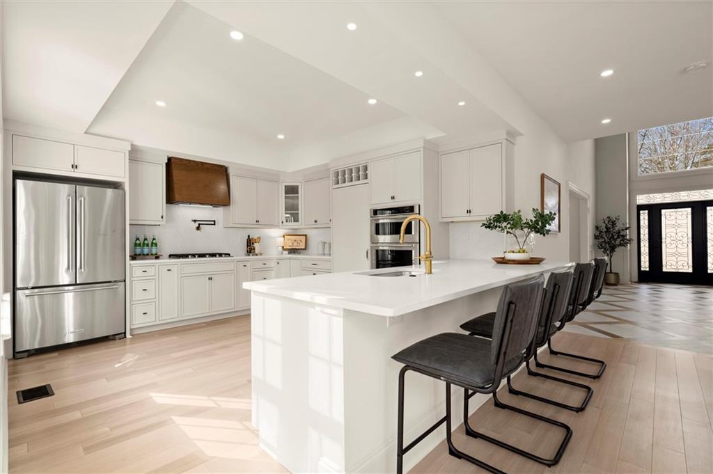 539 Schofield Drive Powder Springs, GA 30127 - Photo 8 of 45 a kitchen with appliances a refrigerator and a stove top oven