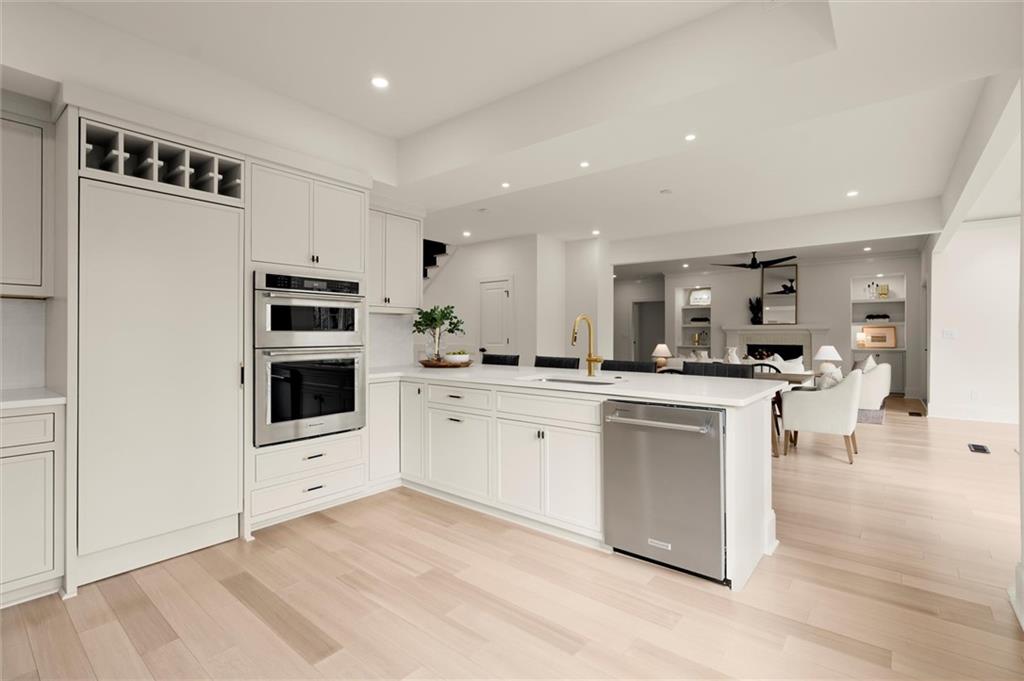 539 Schofield Drive Powder Springs, GA 30127 - Photo 9 of 45 a kitchen with white cabinets and stainless steel appliances